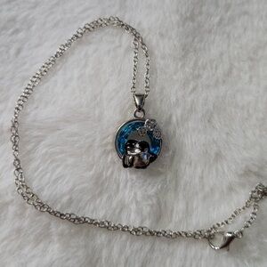 Light blue circle with penguin hugging necklace ￼